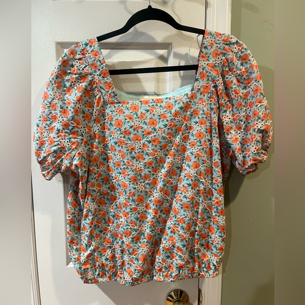 Orange and blue top with subtle puff sleeve